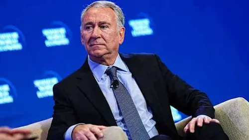 Ken Griffin sits on stage in a suit and tie during the Semafor World Economy Summit, looking to the side.